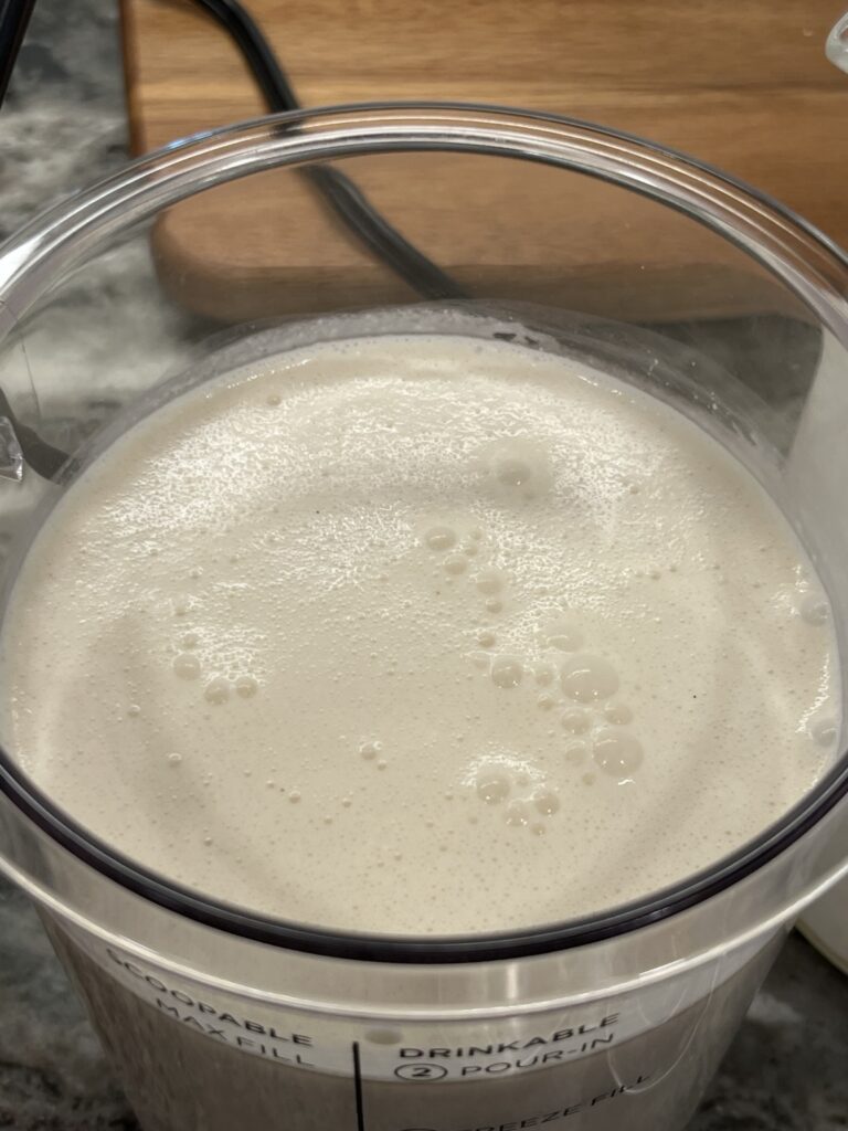 Classic Vanilla Bean ice cream base ready to freeze in a Ninja CREAMi Deluxe container