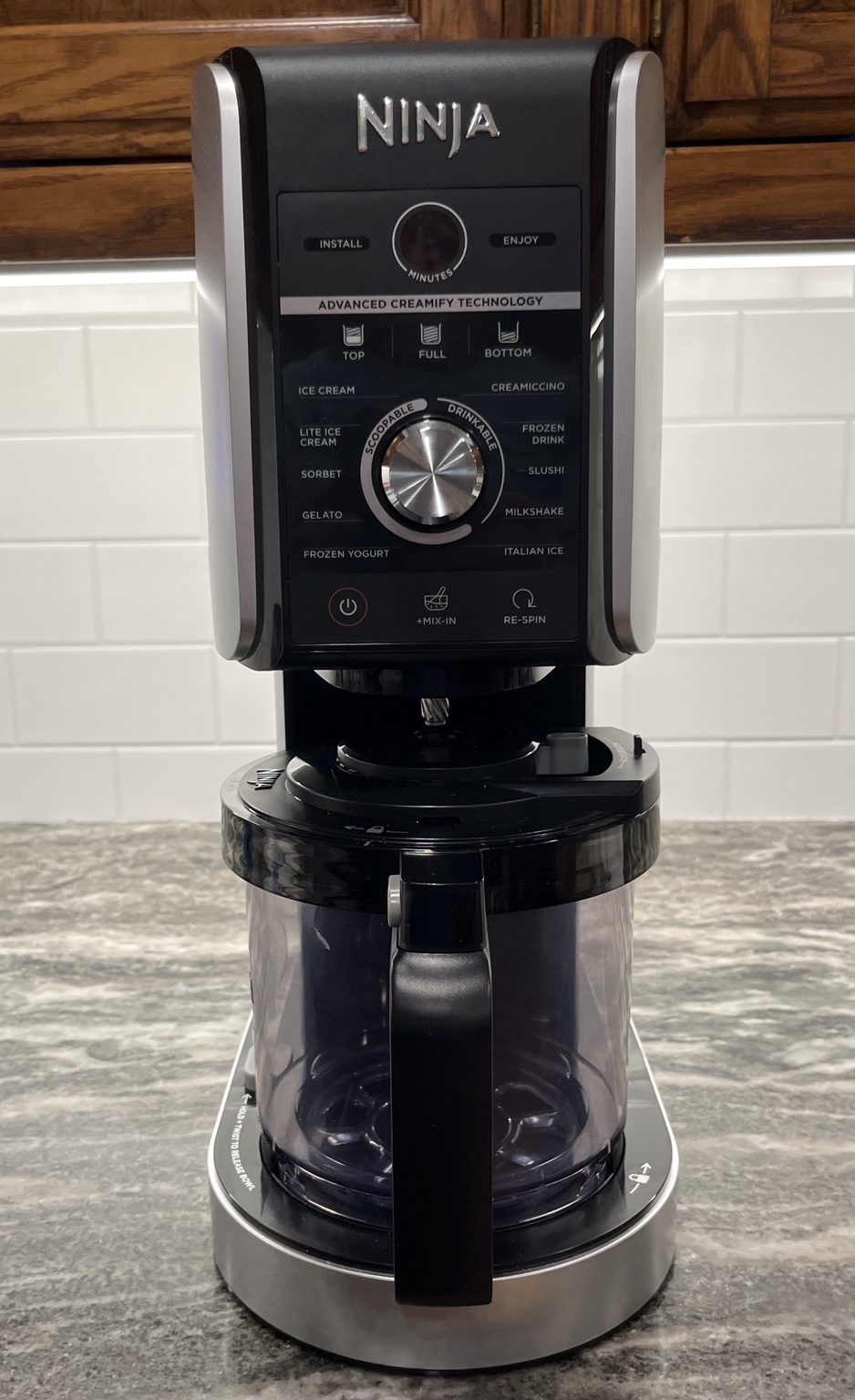 Ninja CREAMi Deluxe NC501 ice cream maker on a kitchen counter used for homemade ice cream recipes