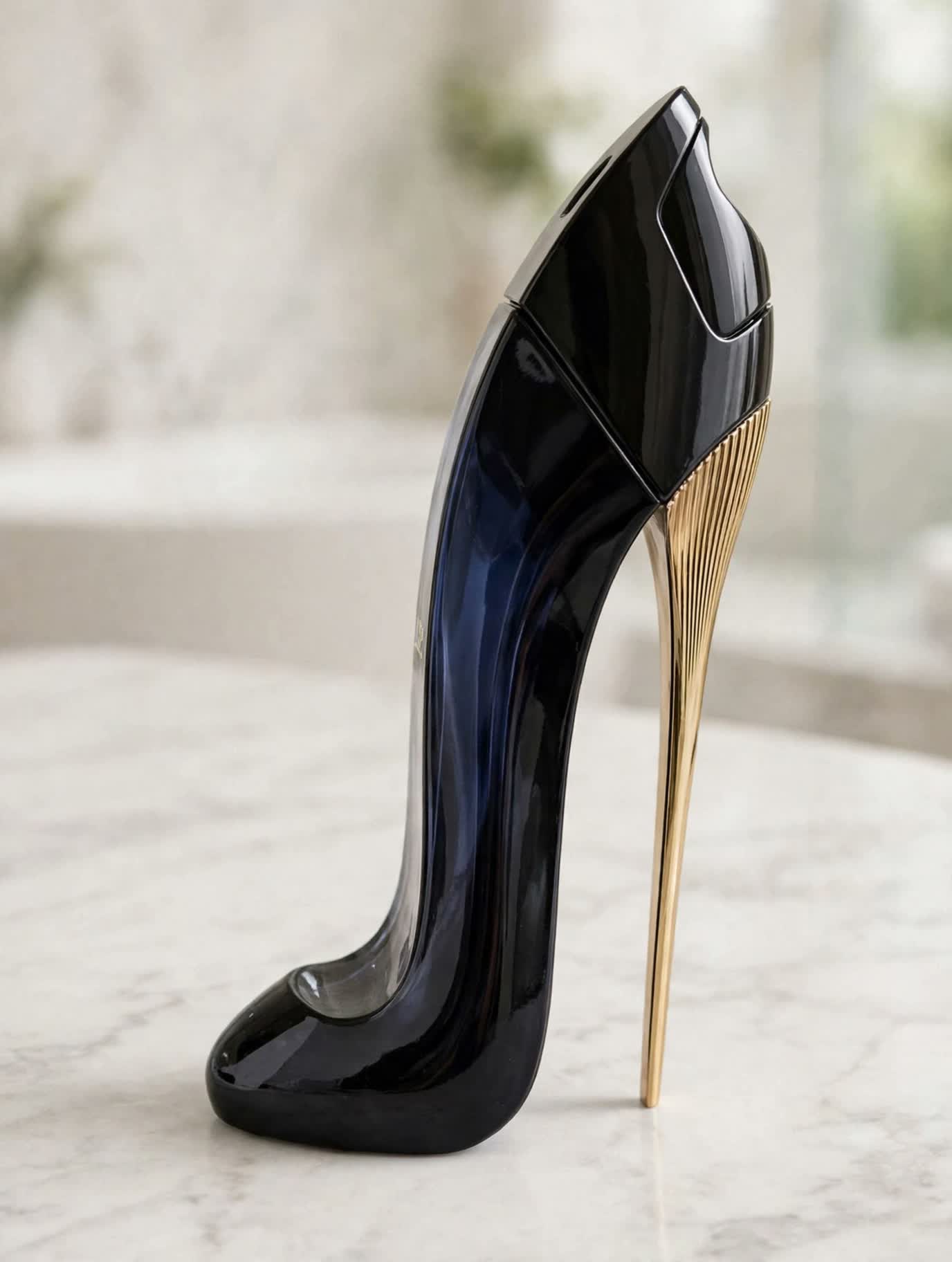 The Carolina Herrera Good Girl eau de parfum black stiletto-heel bottle standing on a marble bathroom counter
