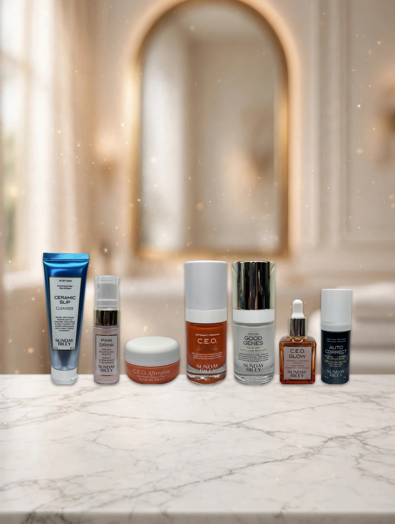The Sunday Riley Wake Up With Me set's seven mini products standing on a marble bathroom counter