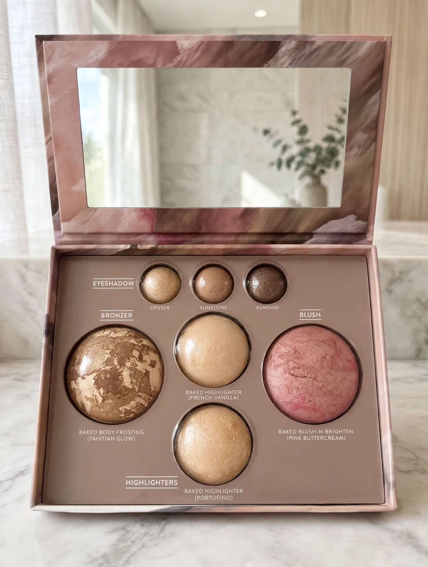 Laura Geller Best of the Best Baked Palette open showing eyeshadows, bronzer, highlighters and blush